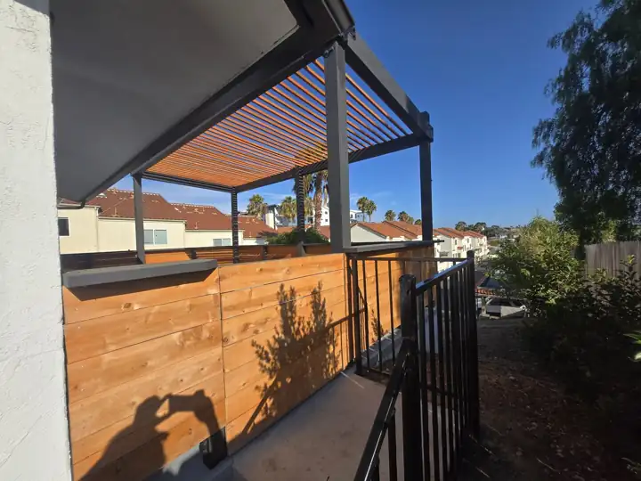 Second-story deck with louvered pergola