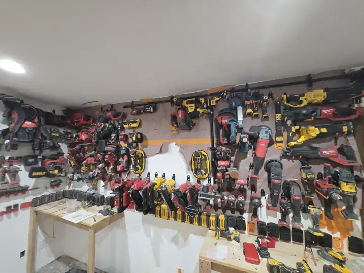 Mid-build: rails up on the white wall, benches roughed in